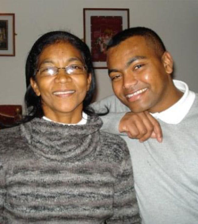 Johnson Beharry smiling with a family member 